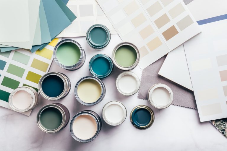 Paint cans and color swatches for interior design.